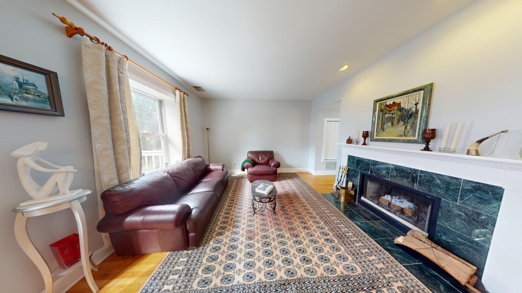 a living room with furniture a rug and a fireplace