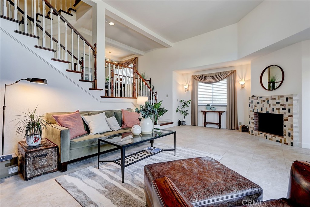 a living room with furniture a fireplace and a rug