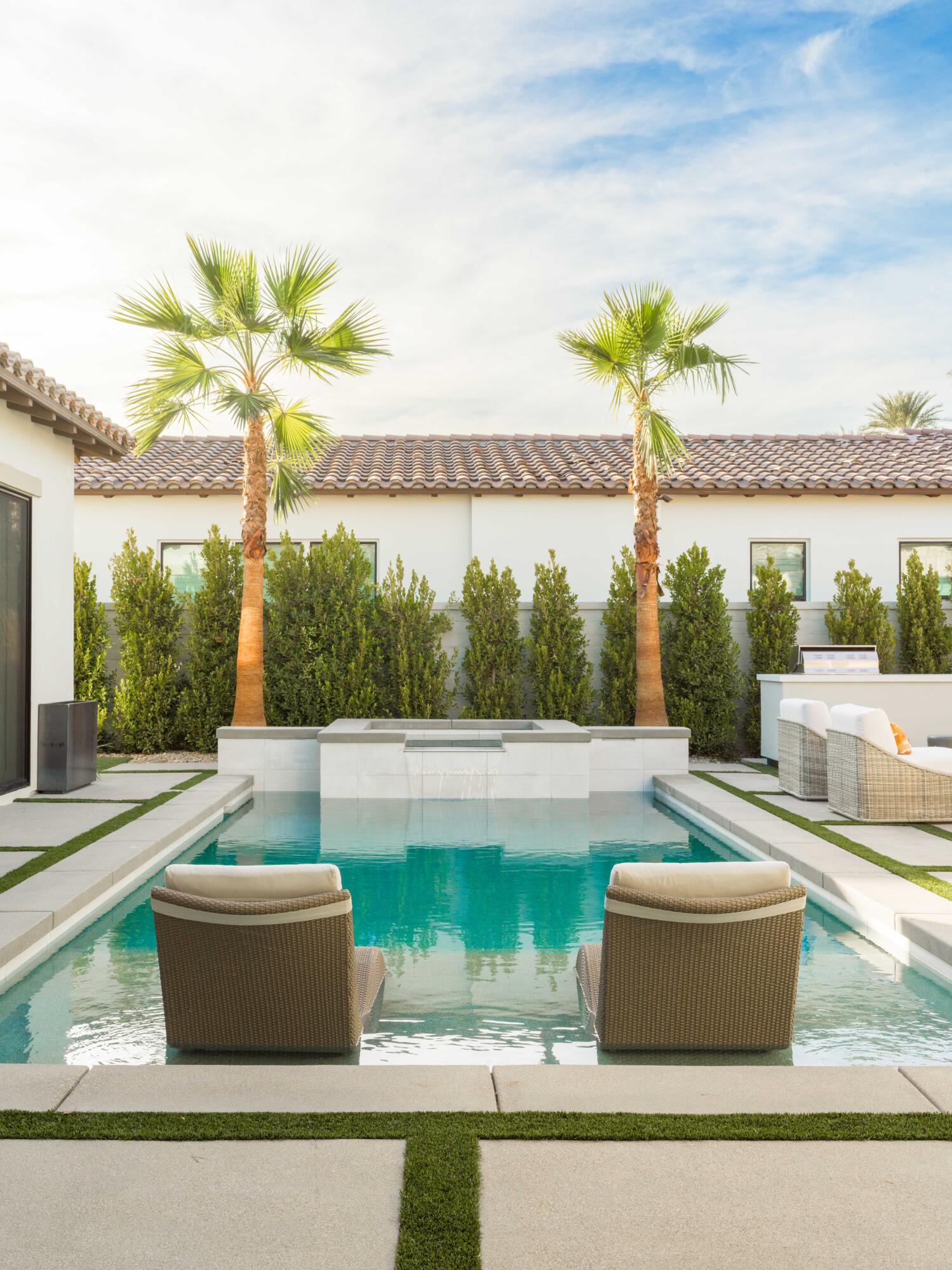 a view of a swimming pool with a patio and a yard