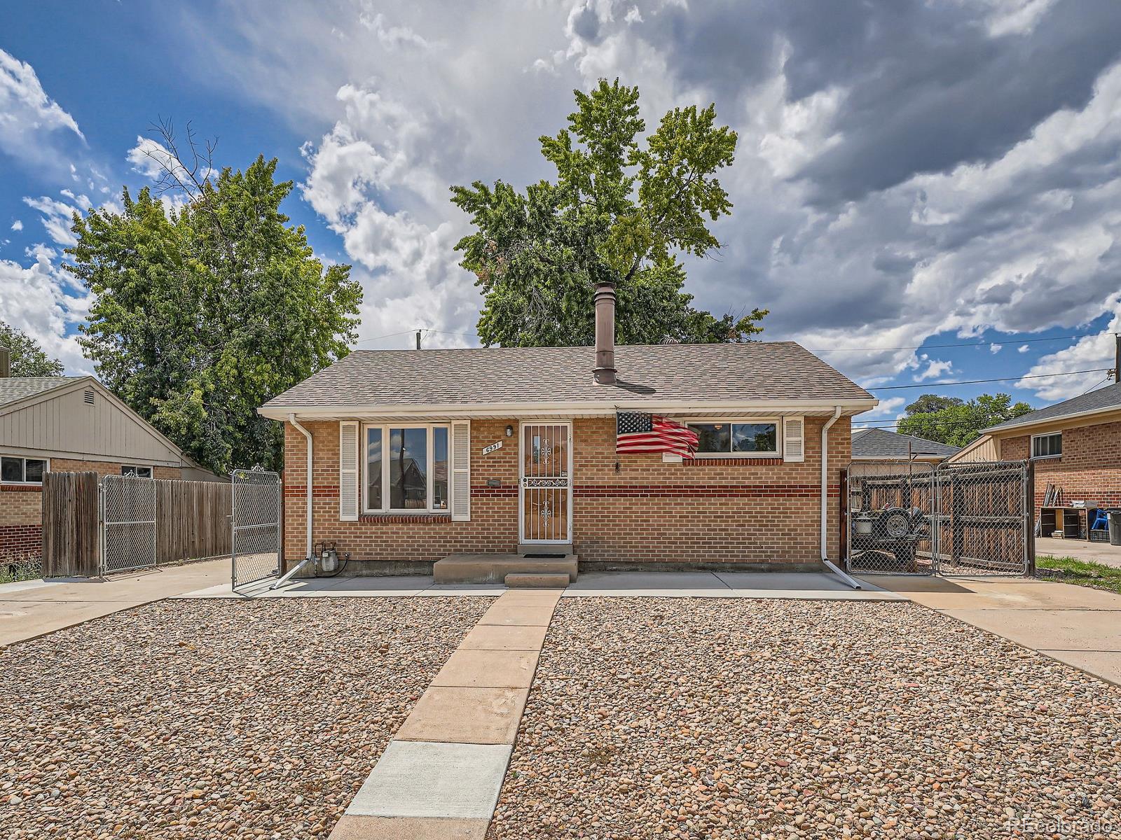 a front view of a house with a yard and a garage