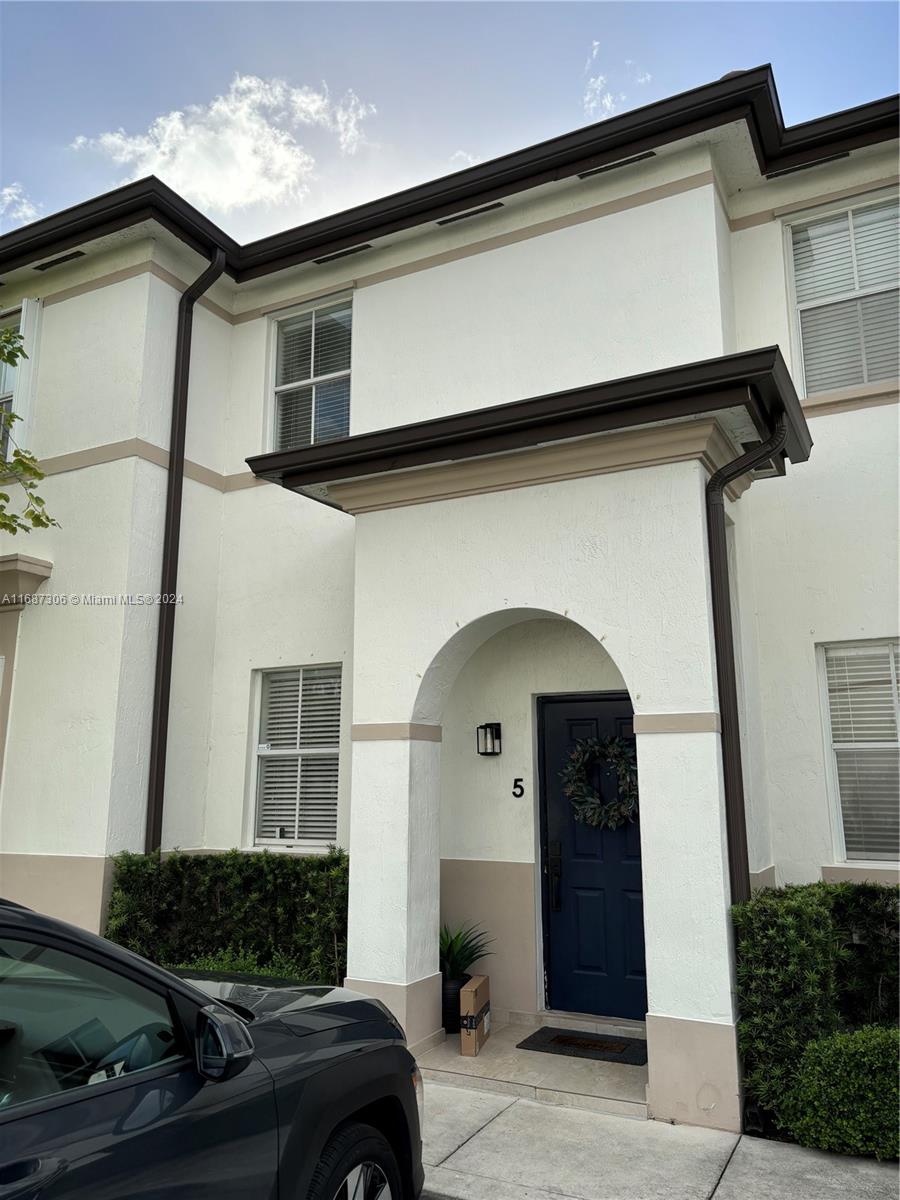 a front view of a house with garage