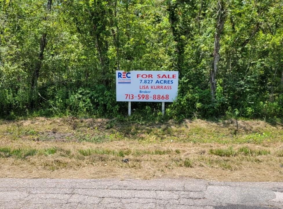 a sign board with wooden fence