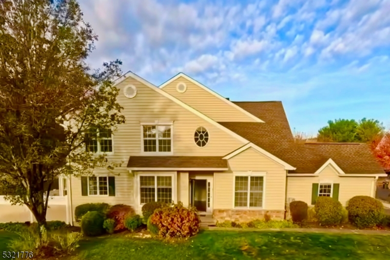 a view of a big house with a big yard and potted plants