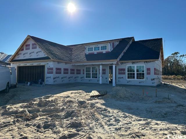 Property under construction featuring a garage