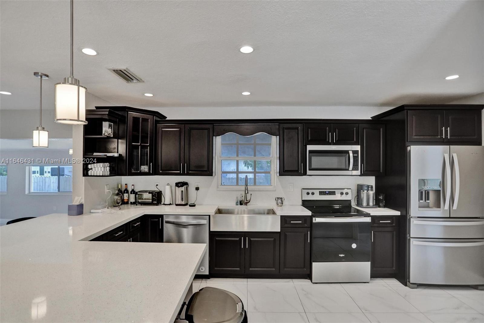 a kitchen with a sink stainless steel appliances and cabinets