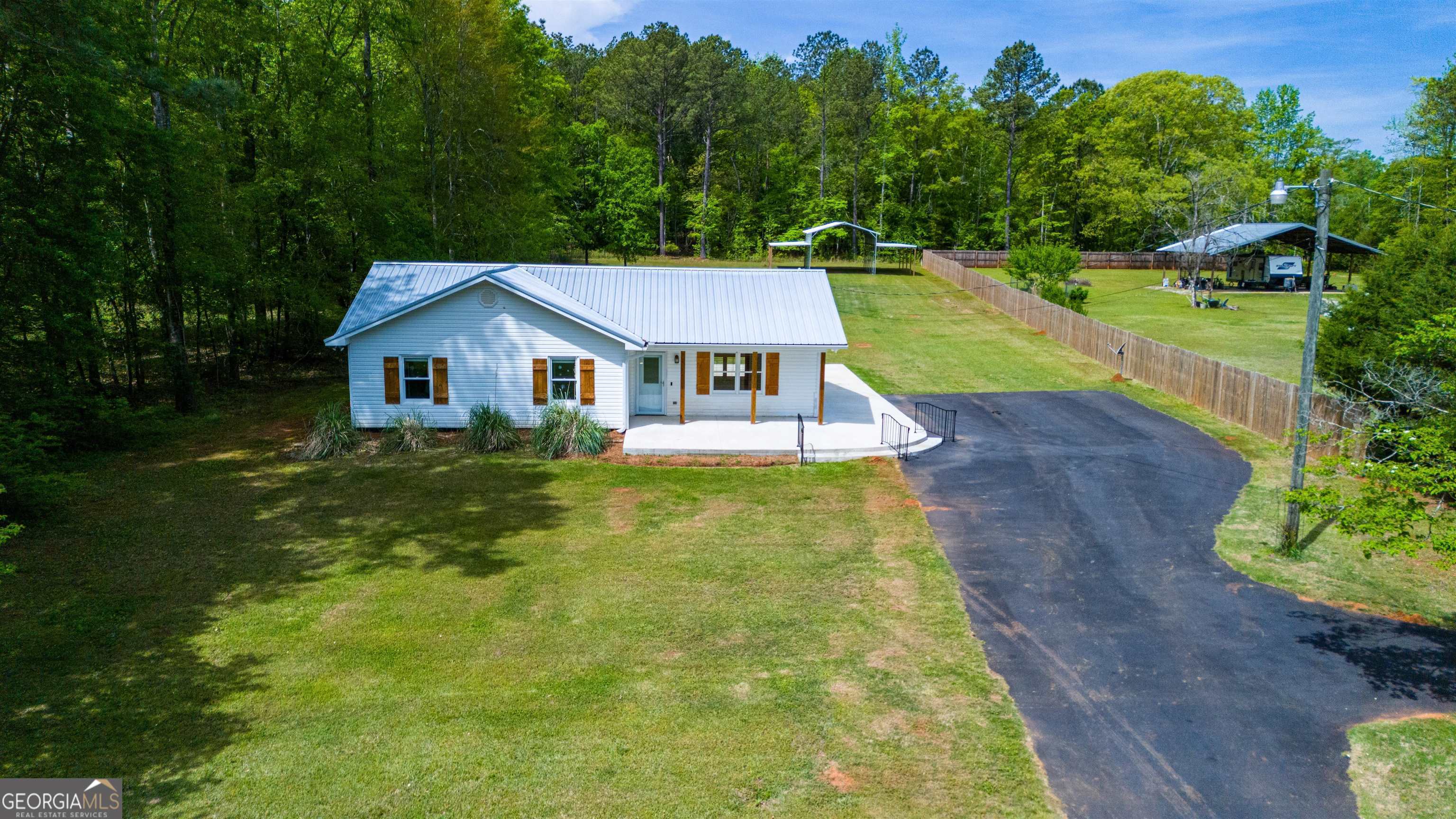 a house with green field in front of it