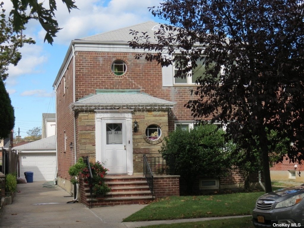 a front view of a house with garden