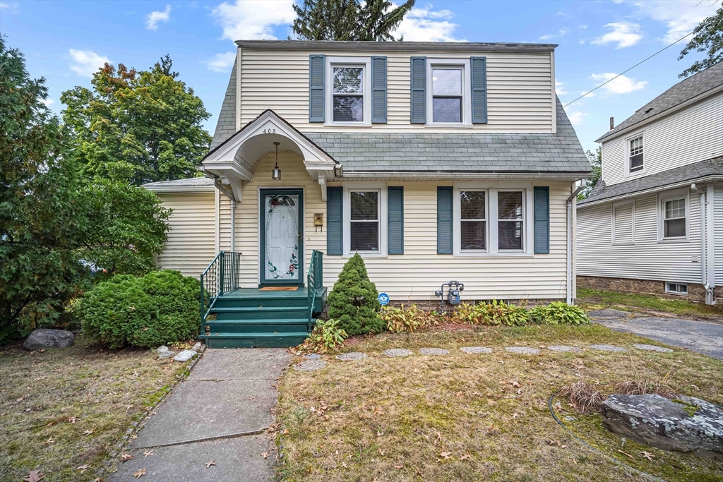 a front view of a house with garden