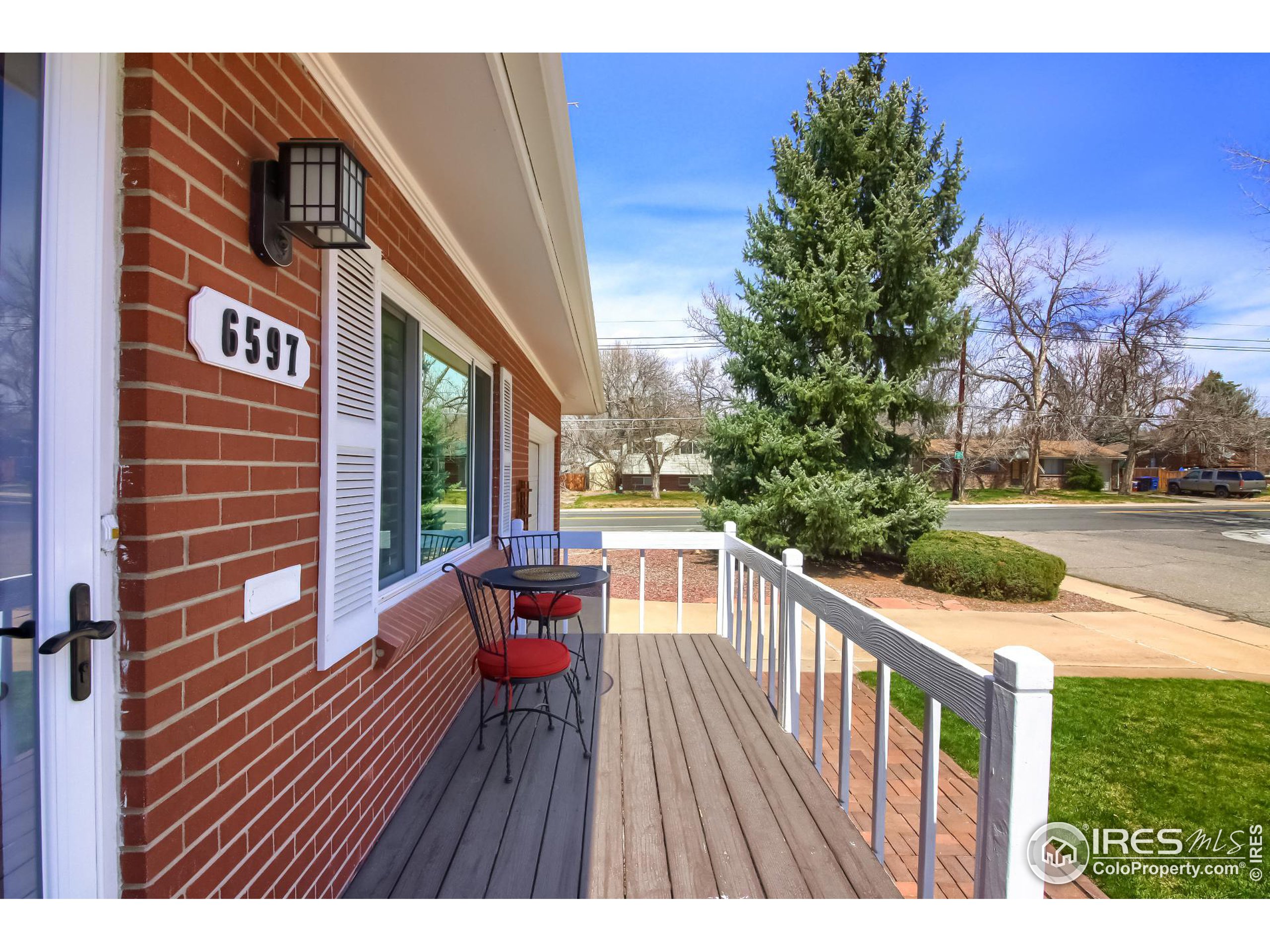 a view of deck with furniture and trees around