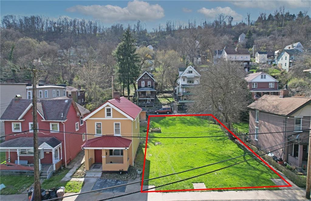 a aerial view of a houses with yard