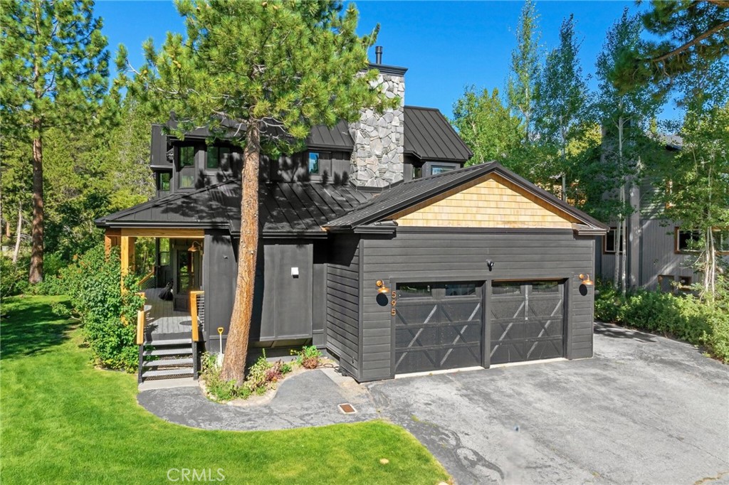 a front view of a house with a yard garage and outdoor seating