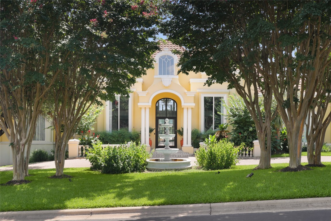 a front view of a house with a garden