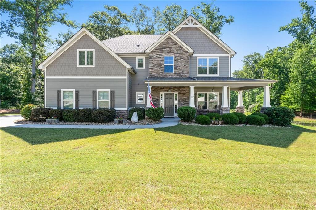 a front view of house with yard and green space