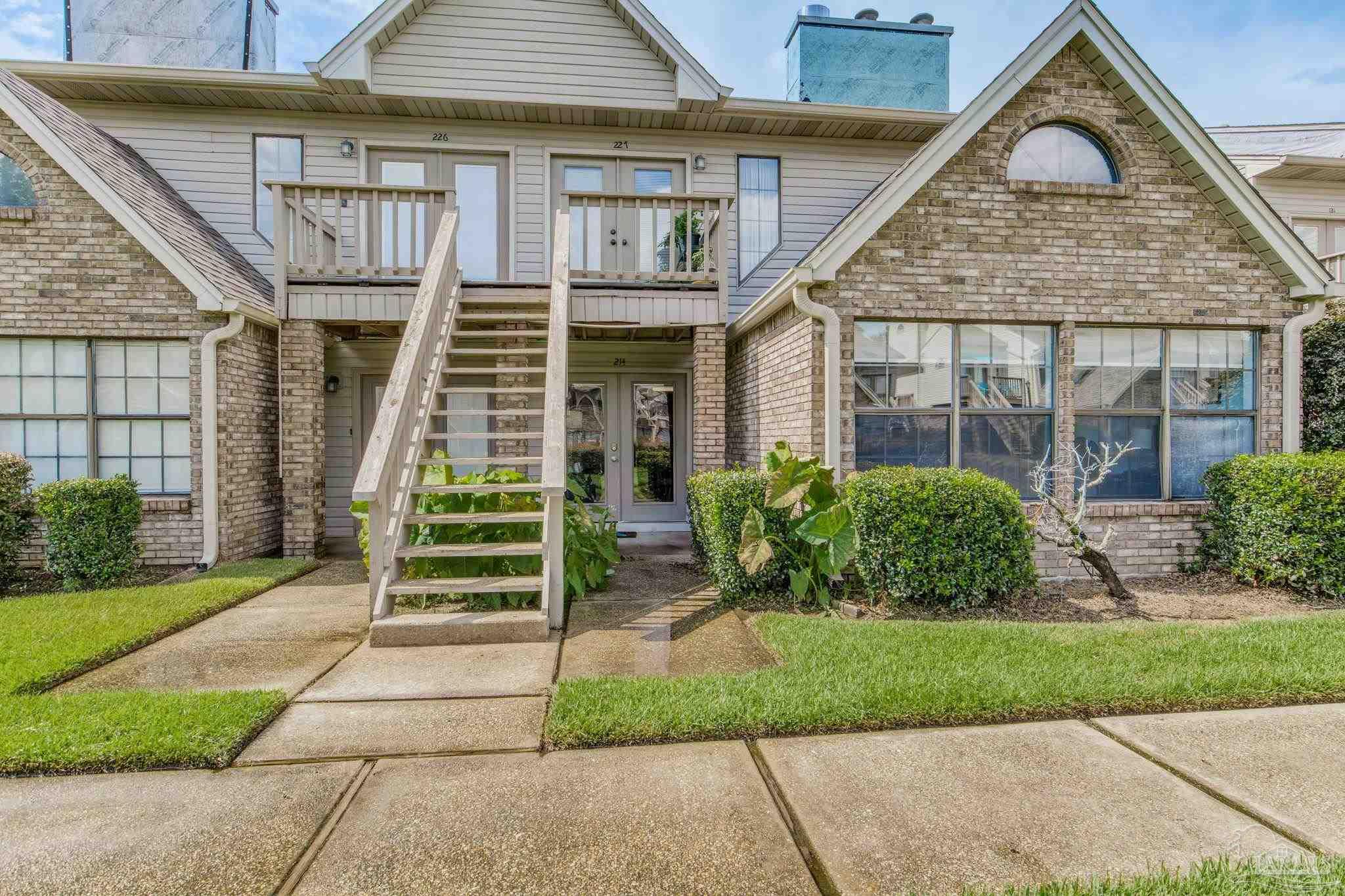 a front view of a house with a garden