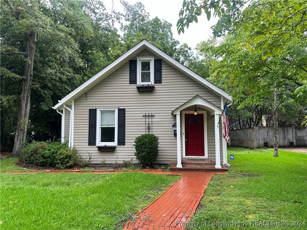 a front view of house with yard and green space