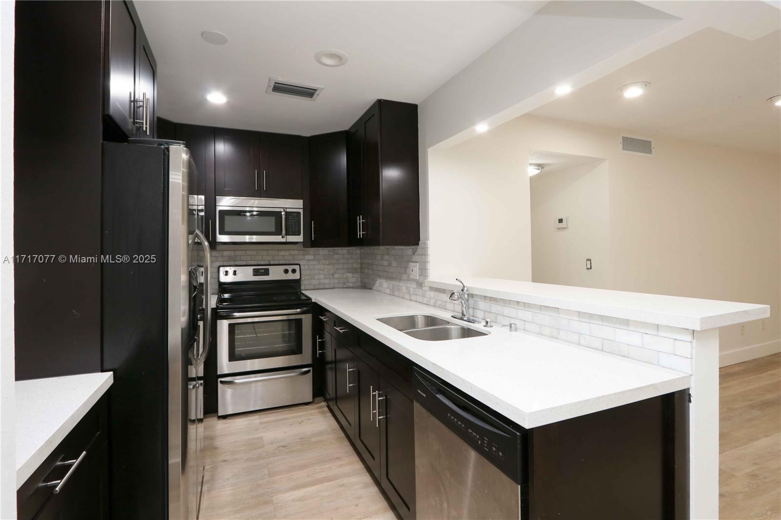 a kitchen with a sink stove and refrigerator