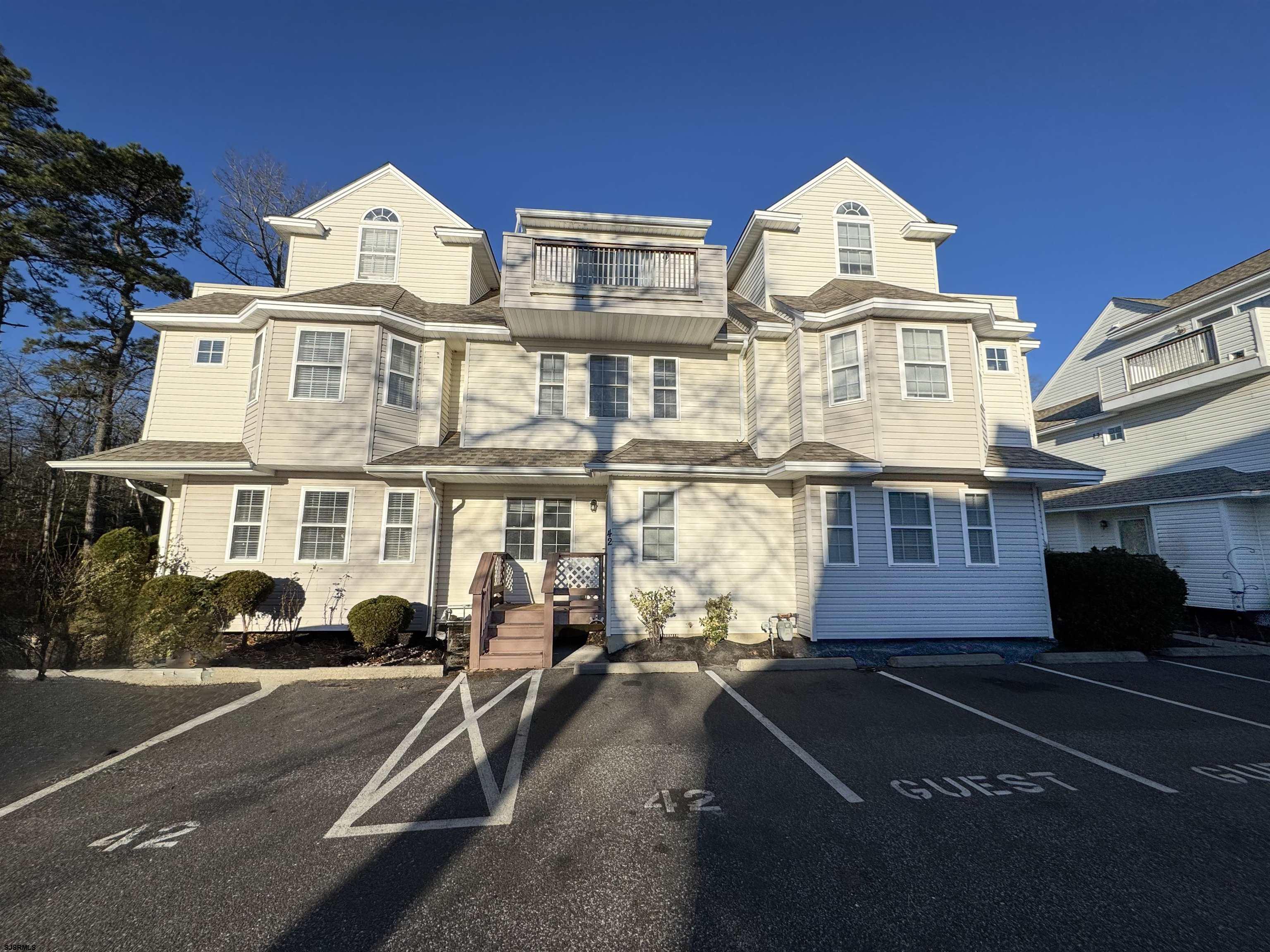 a front view of a residential apartment building with a yard