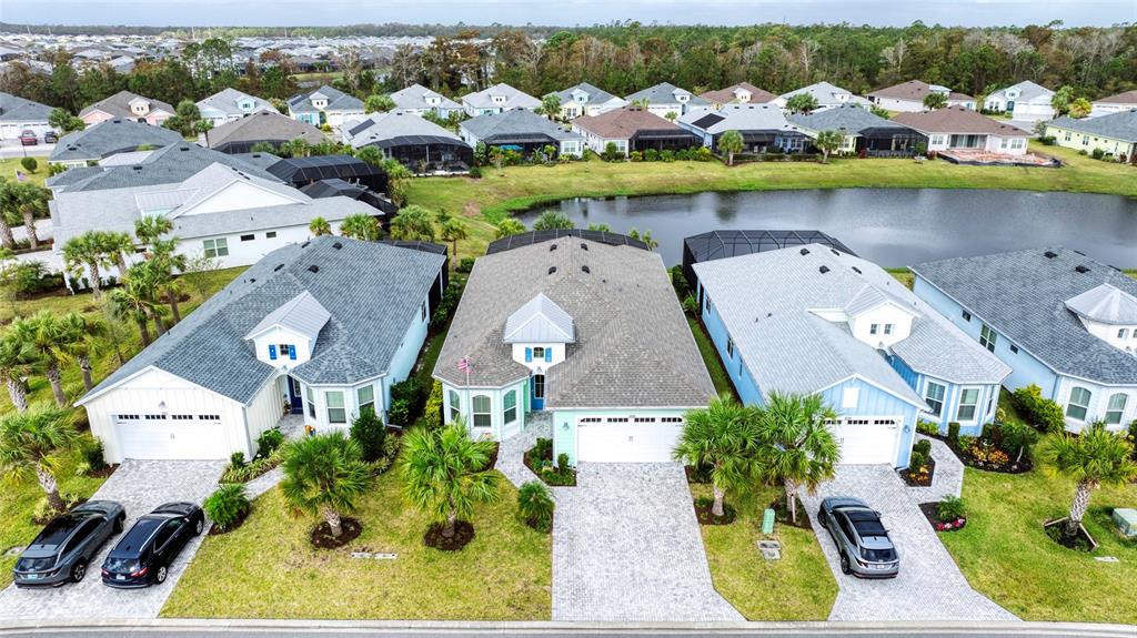 an aerial view of a house with swimming pool lake view and mountain view