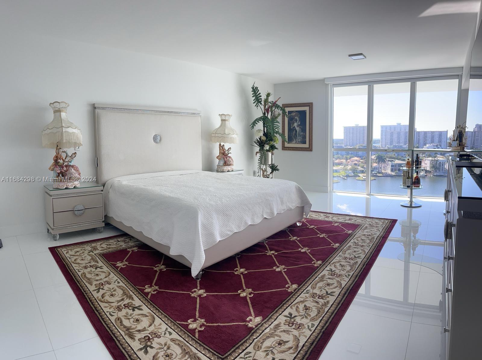 a bedroom with a bed rug and window