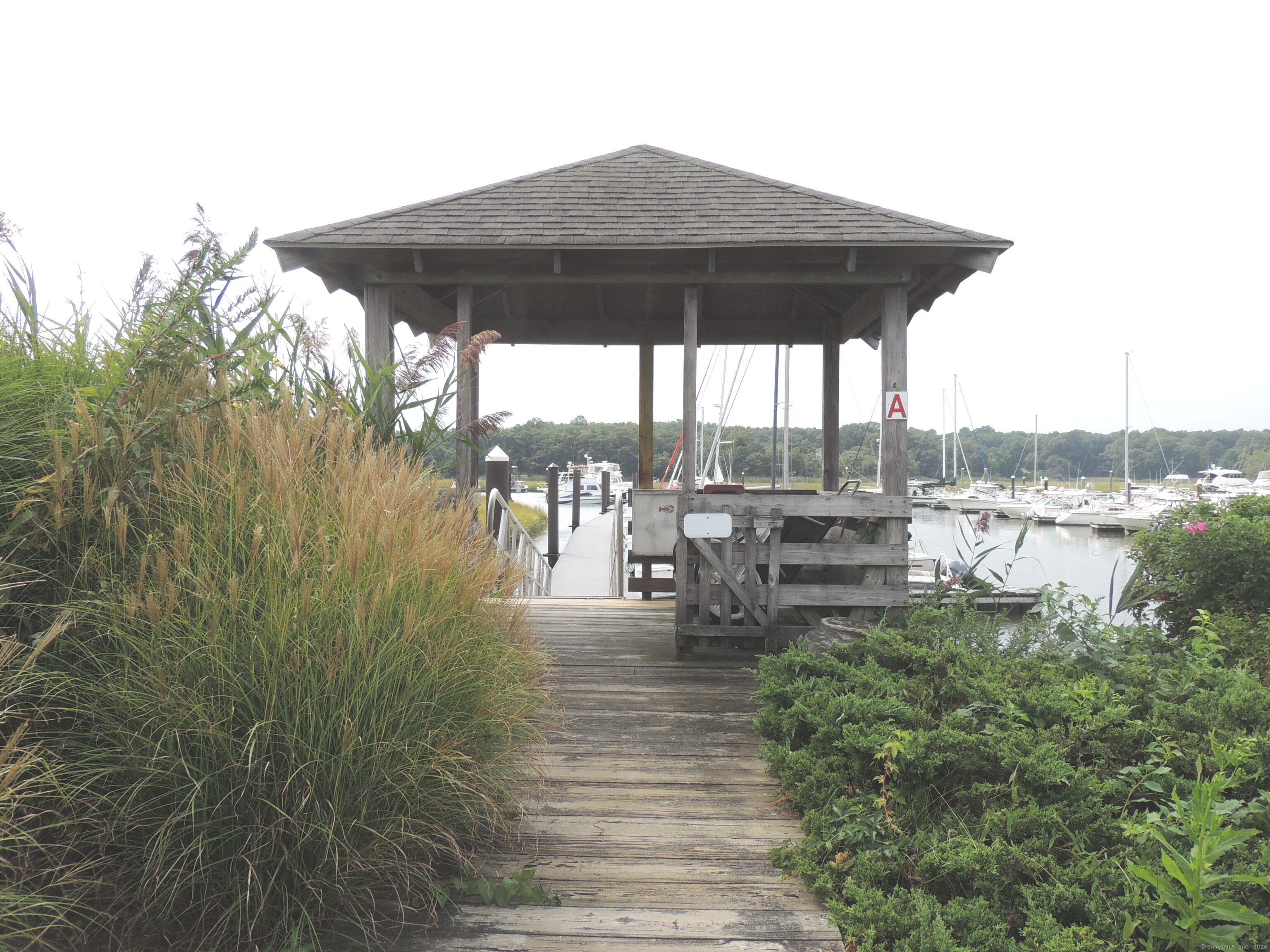 a view of a patio with table and chairs under an umbrella