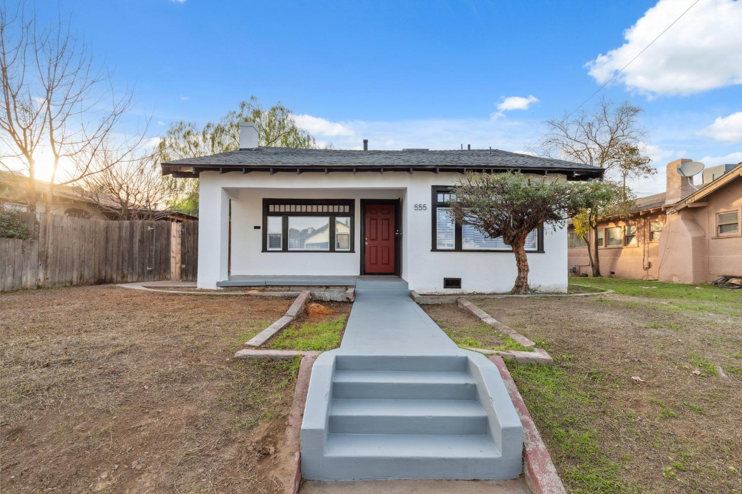 a front view of a house with a yard