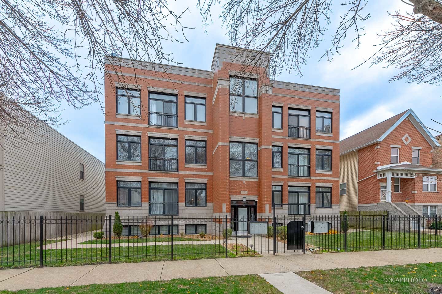 a view of a brick building next to a yard