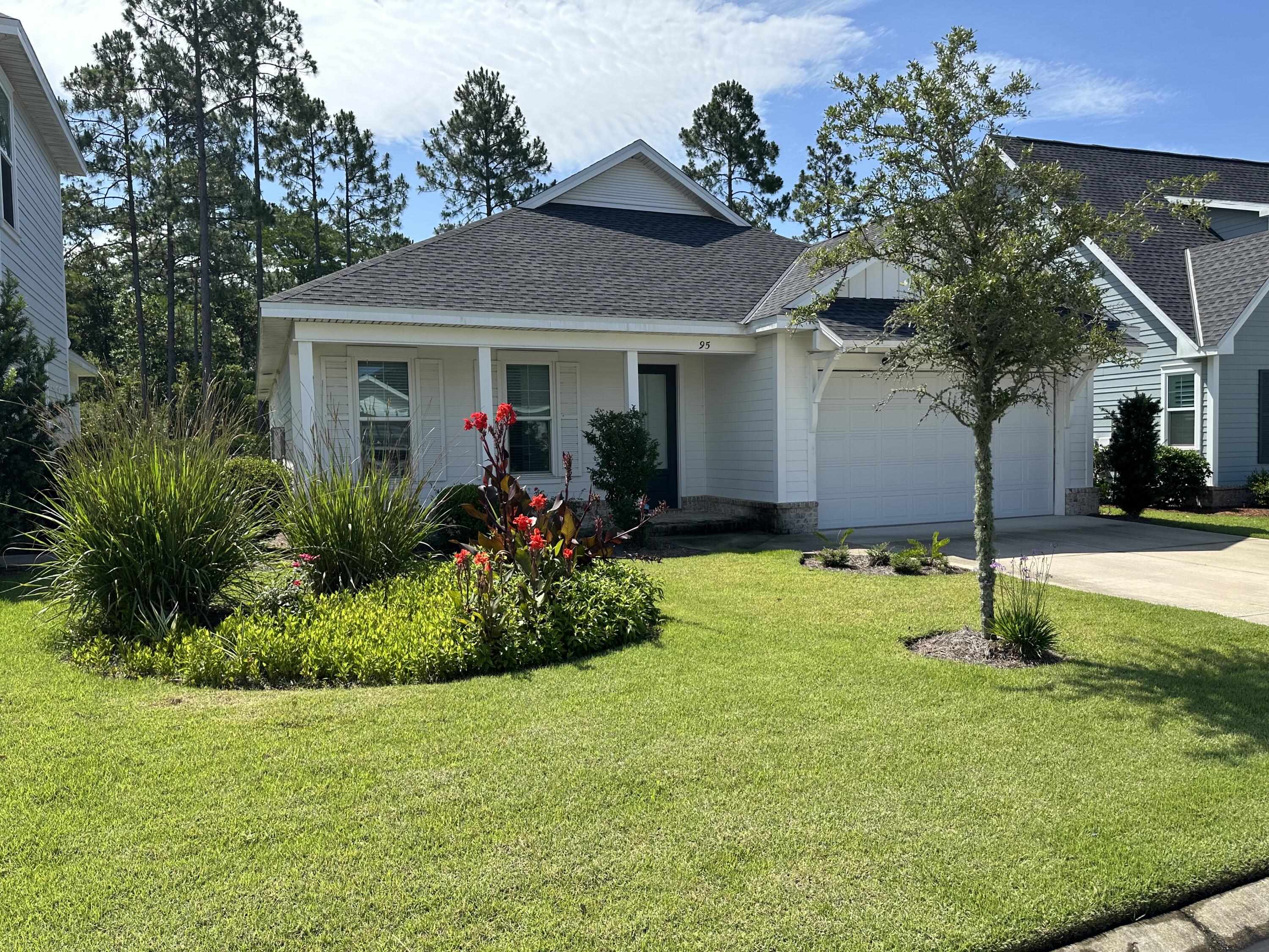 a front view of house with a garden