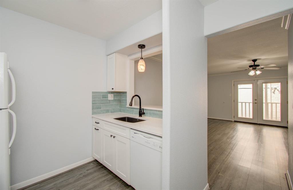 a kitchen with a sink and a mirror