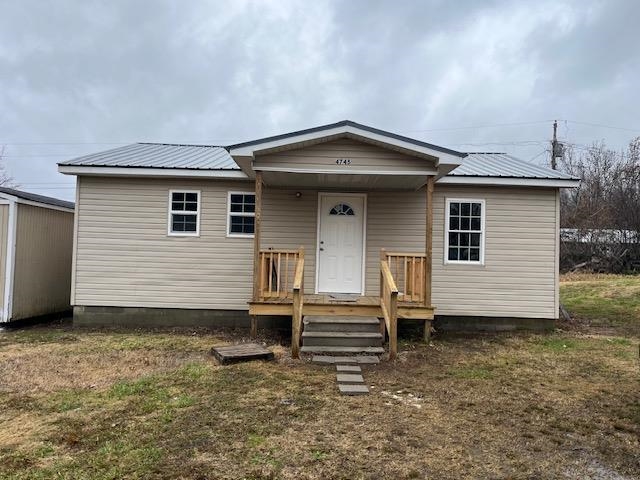 View of front of property with a front lawn