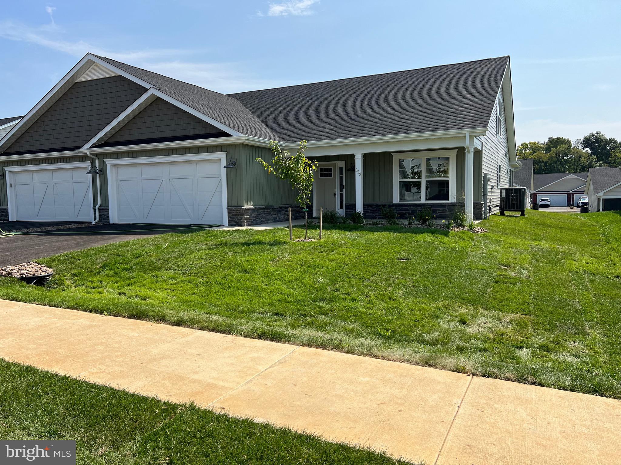 a front view of a house with a garden and yard