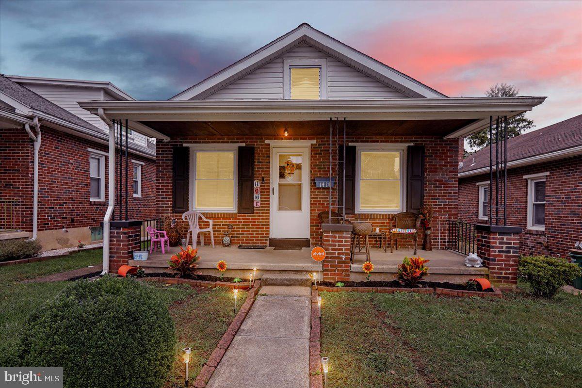 a front view of a house with outdoor seating