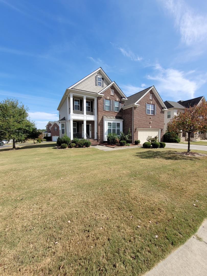 a front view of a house with a yard