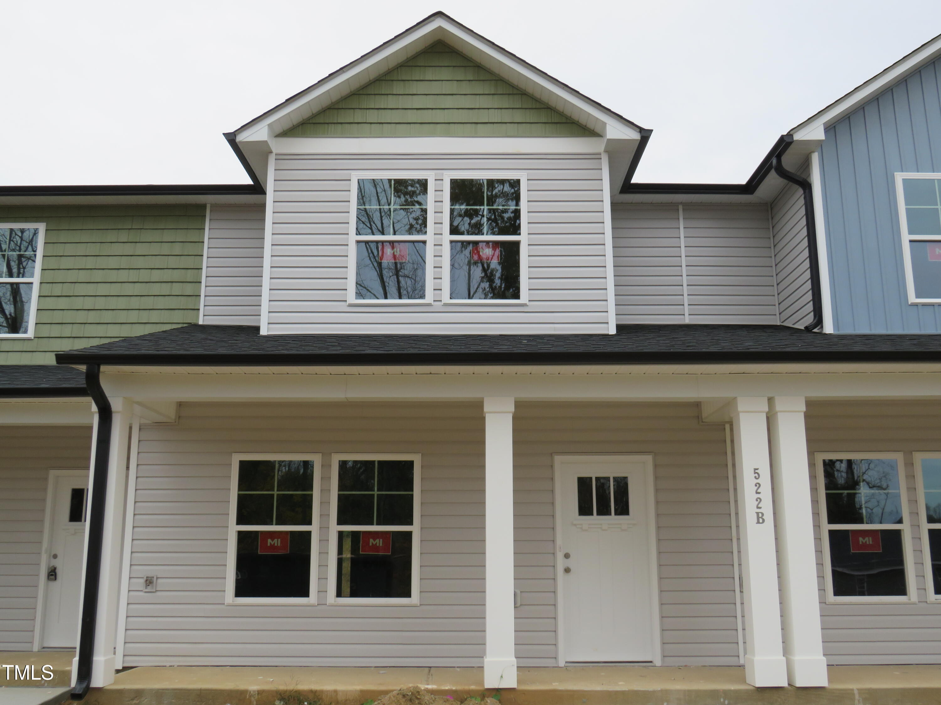 a view of brick house with large windows