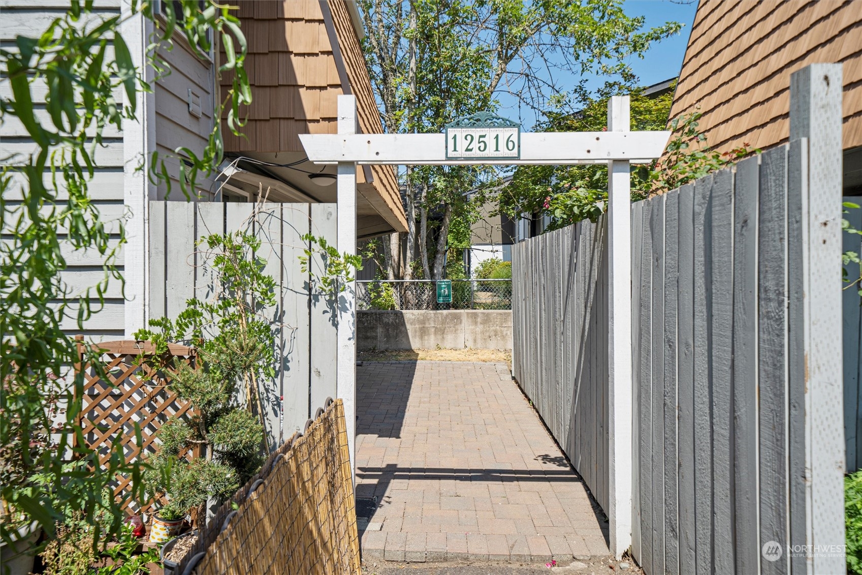 a view of outdoor space with a sink and garden in the background