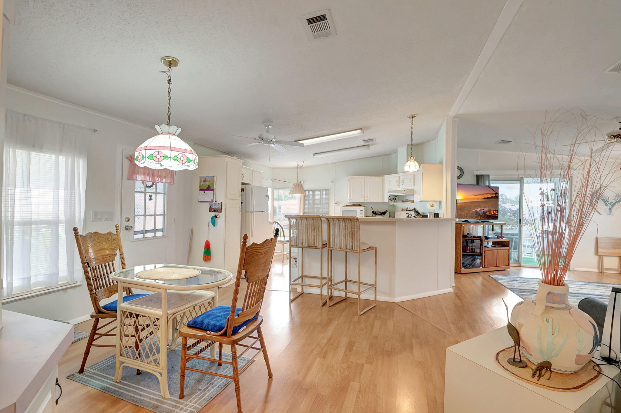 a dining room with furniture window and wooden floor