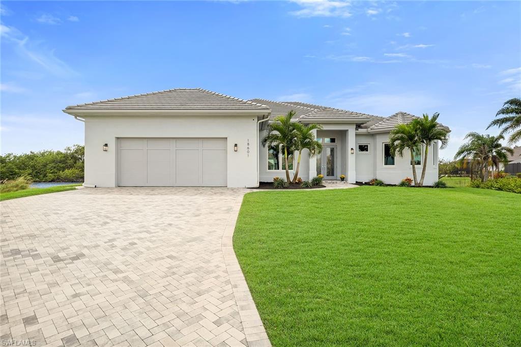 a front view of a house with a yard and garage