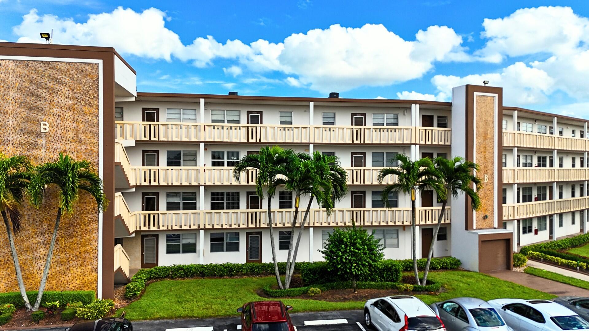 a front view of a residential apartment building with a yard