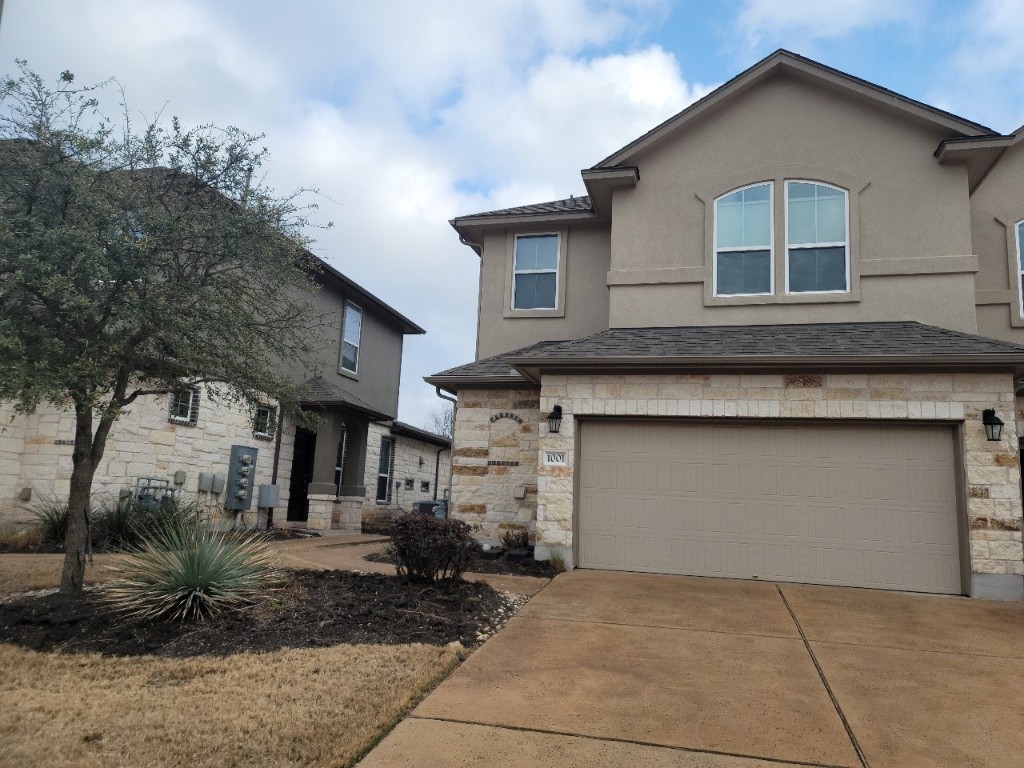 a front view of a house with garden