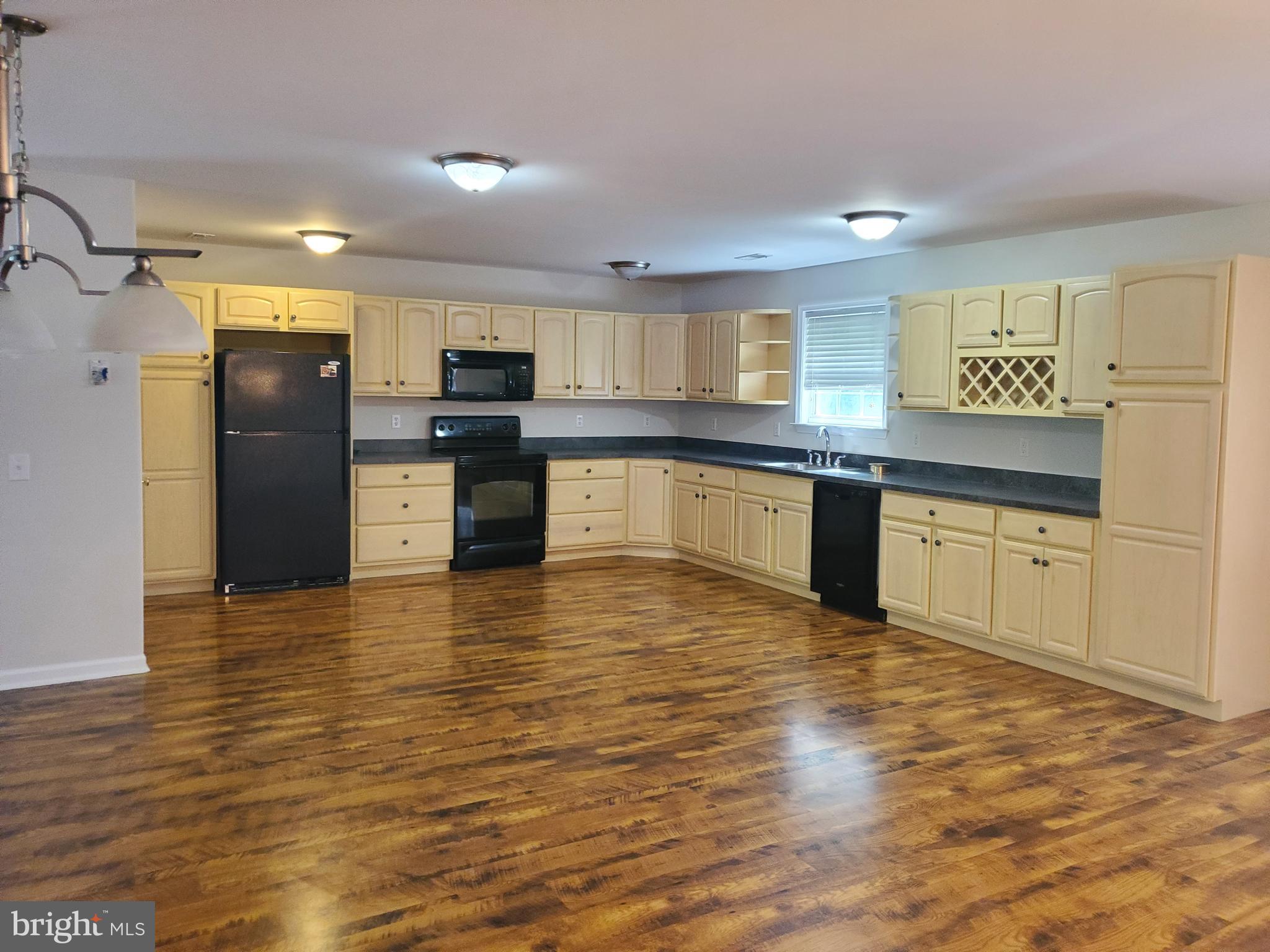 a kitchen with stainless steel appliances granite countertop a refrigerator sink and cabinets