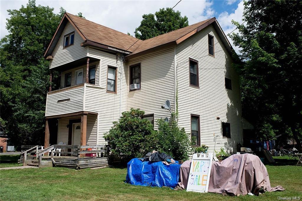 a front view of house with yard and outdoor seating