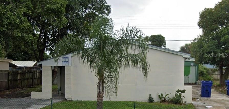 a view of a house with a tree in front