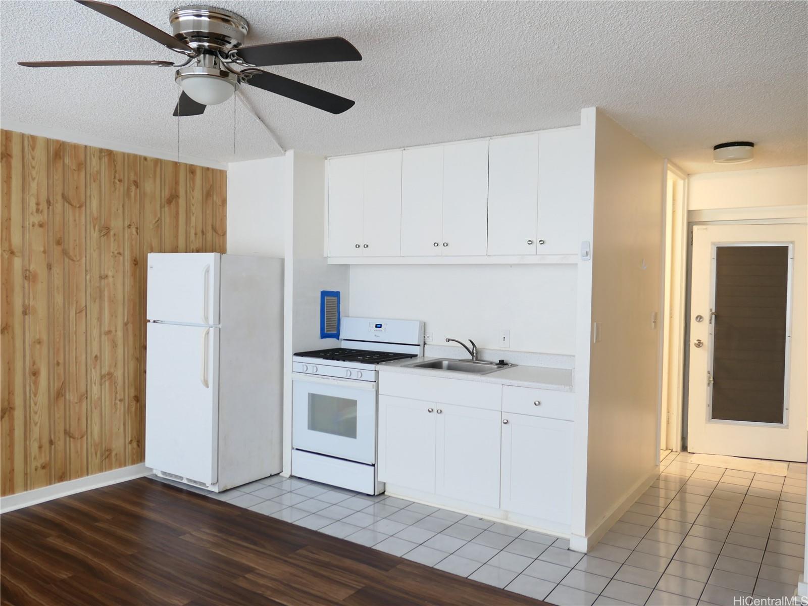 a kitchen with white cabinets and white appliances