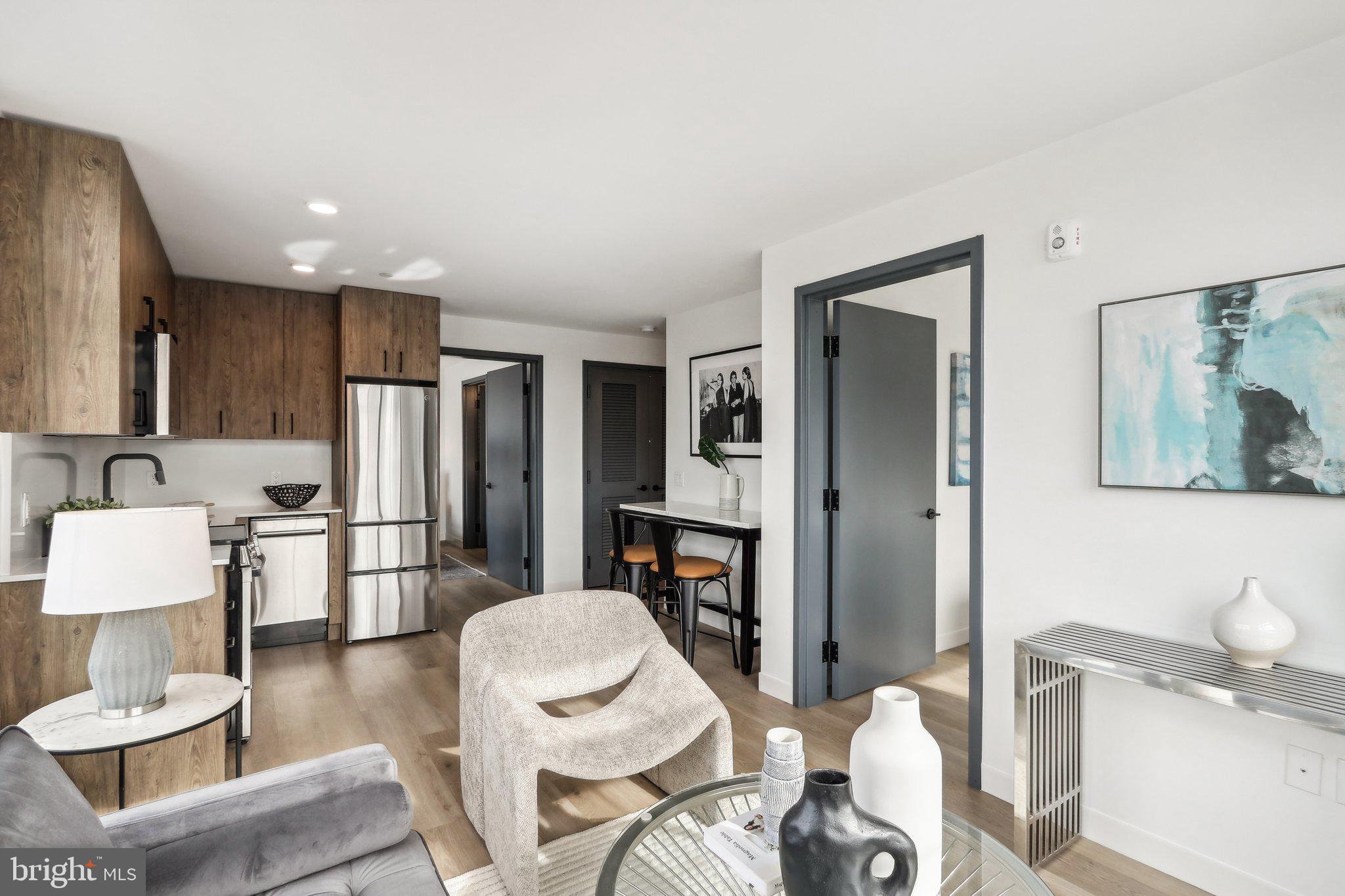 a living room with furniture and a kitchen view