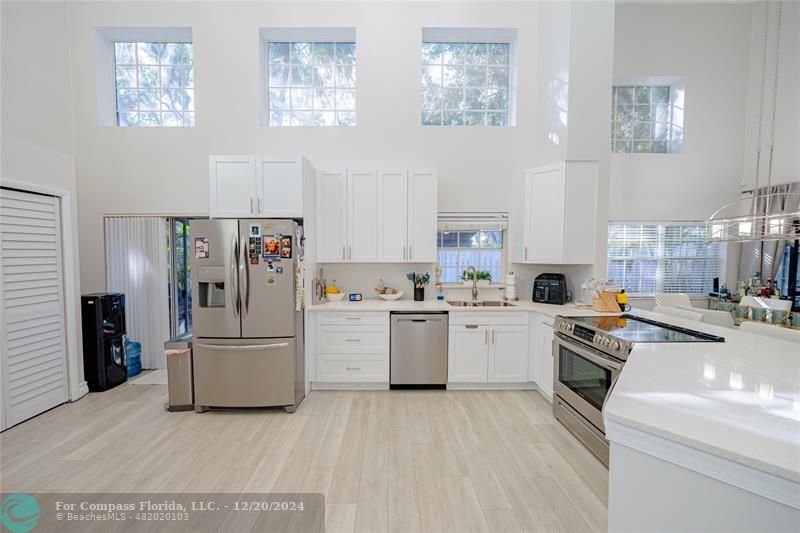 a kitchen with cabinets and refrigerator