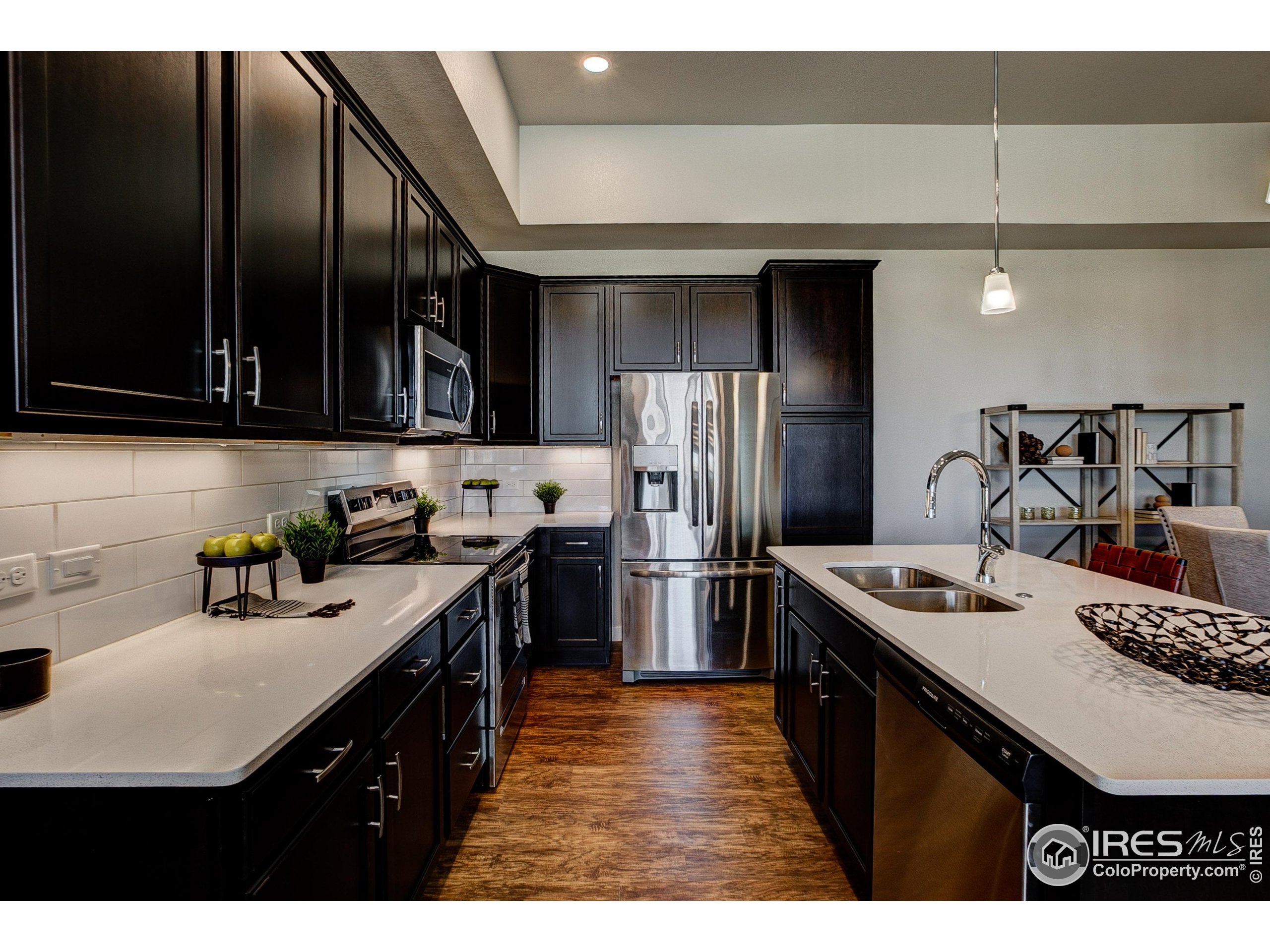 a kitchen with stainless steel appliances a sink stove and refrigerator