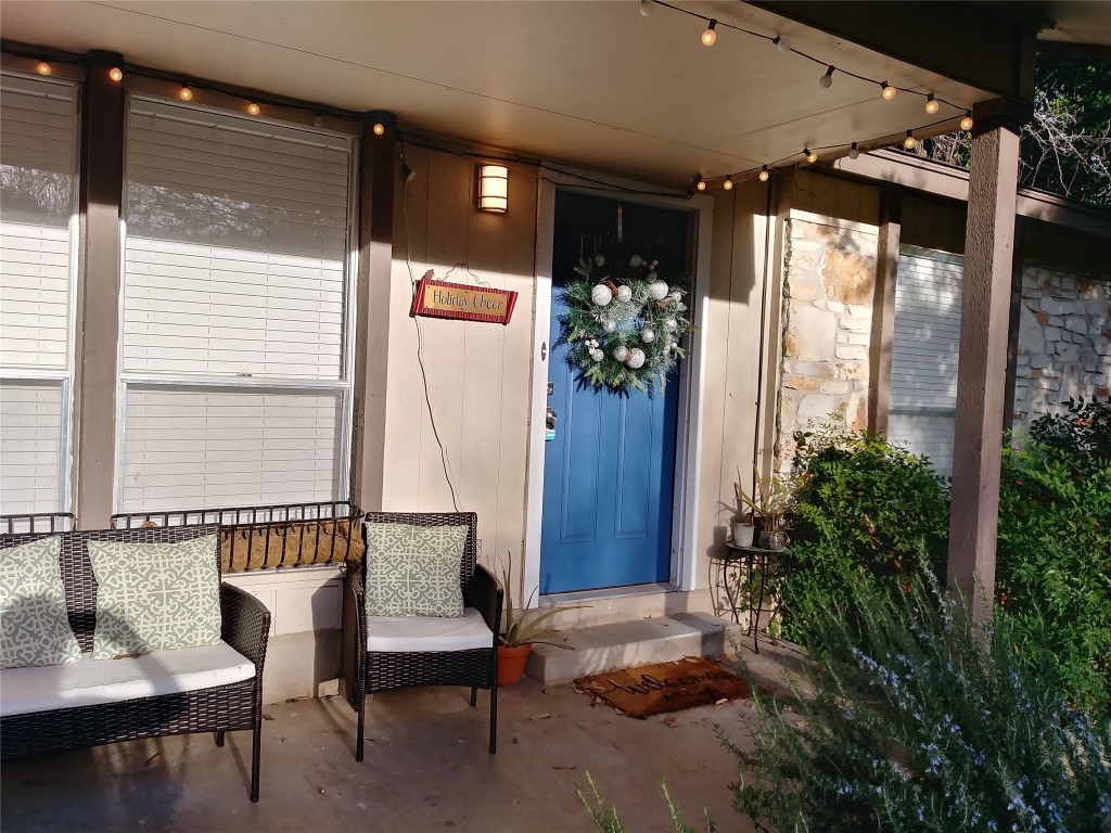 a balcony with furniture and potted plants