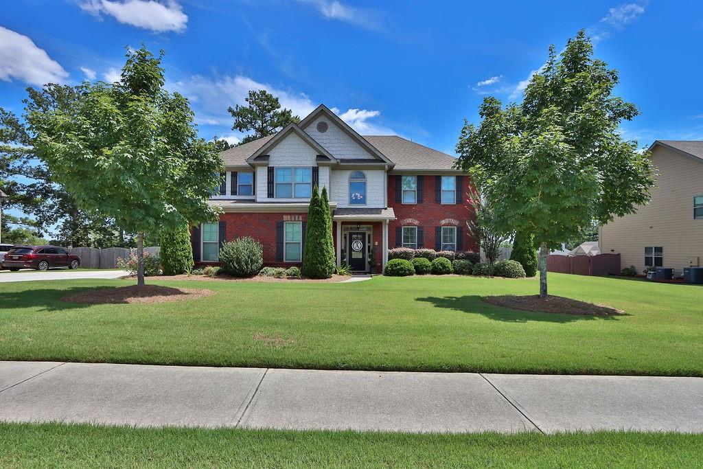 a front view of a house with a yard