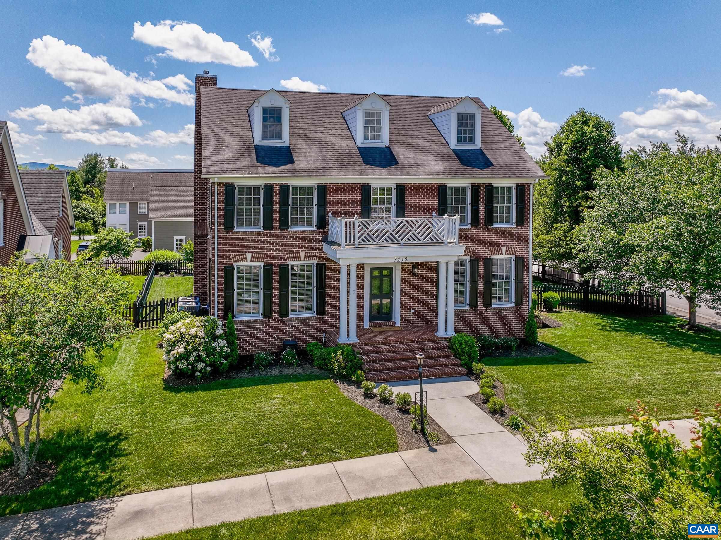 Elegant brick home in the heart of Old Trail with mature trees and plantings.