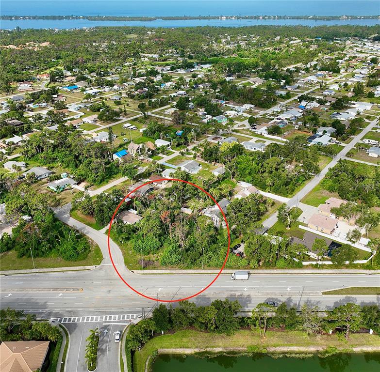 an aerial view of residential houses with outdoor space and trees