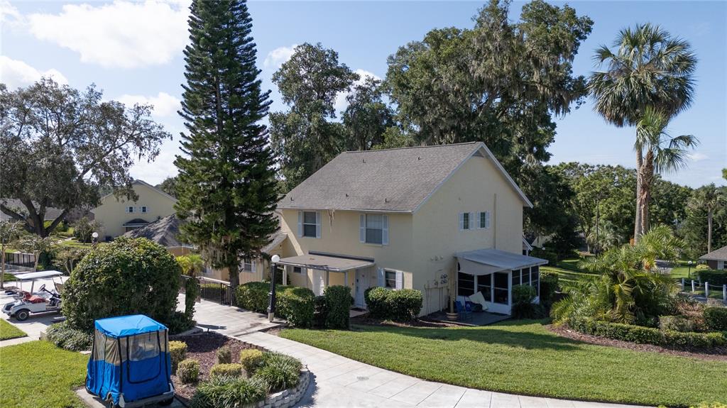 a aerial view of a house with a yard and potted plants